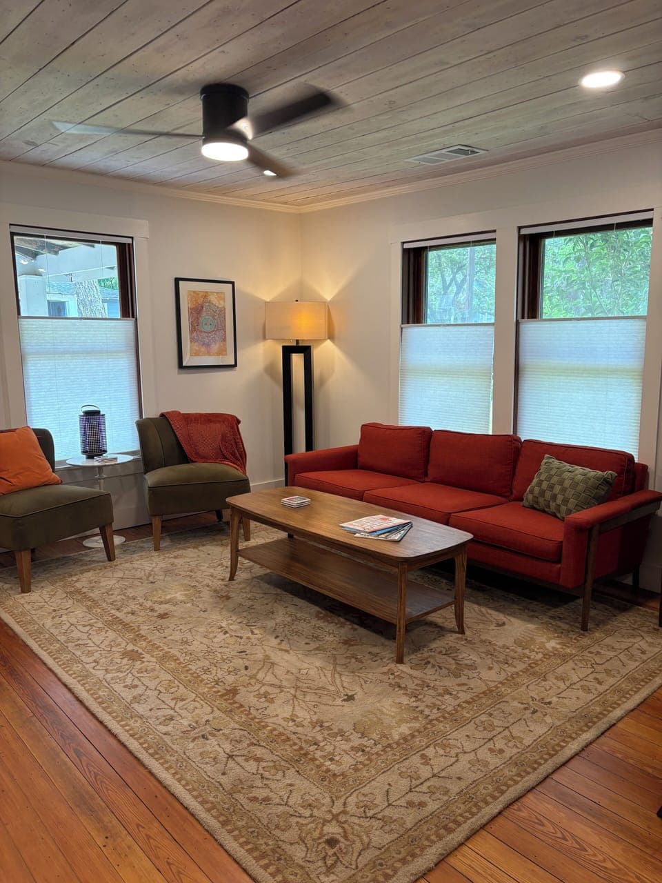 Enjoying comfy furniture, warmth of the original wood floors, and natural light.
