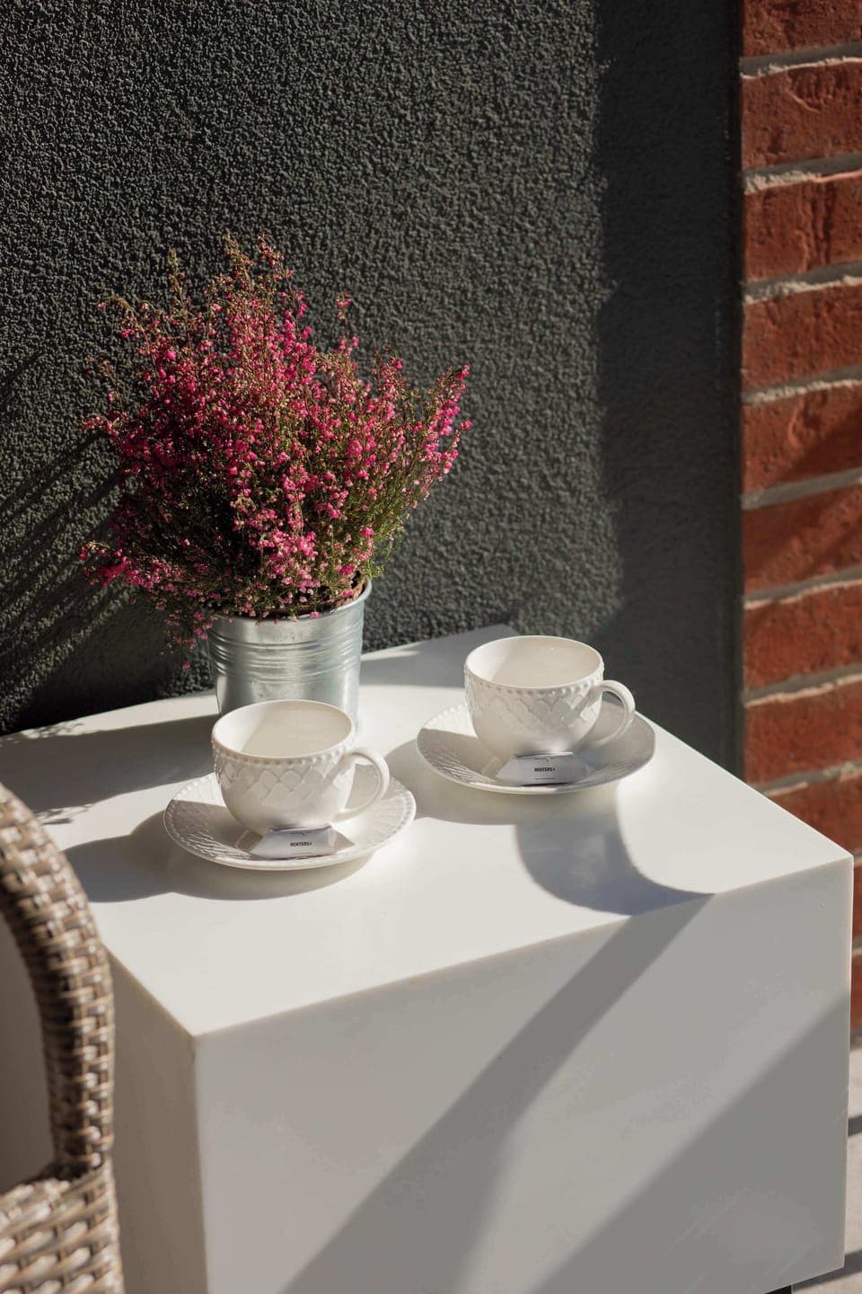 Furnished balcony with green surroundings. 