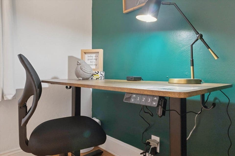 Power up your productivity in our South Bend guest retreat—featuring an electric standing desk with built-in outlets, charging ports, and a comfy chair. Perfect for remote work near Notre Dame