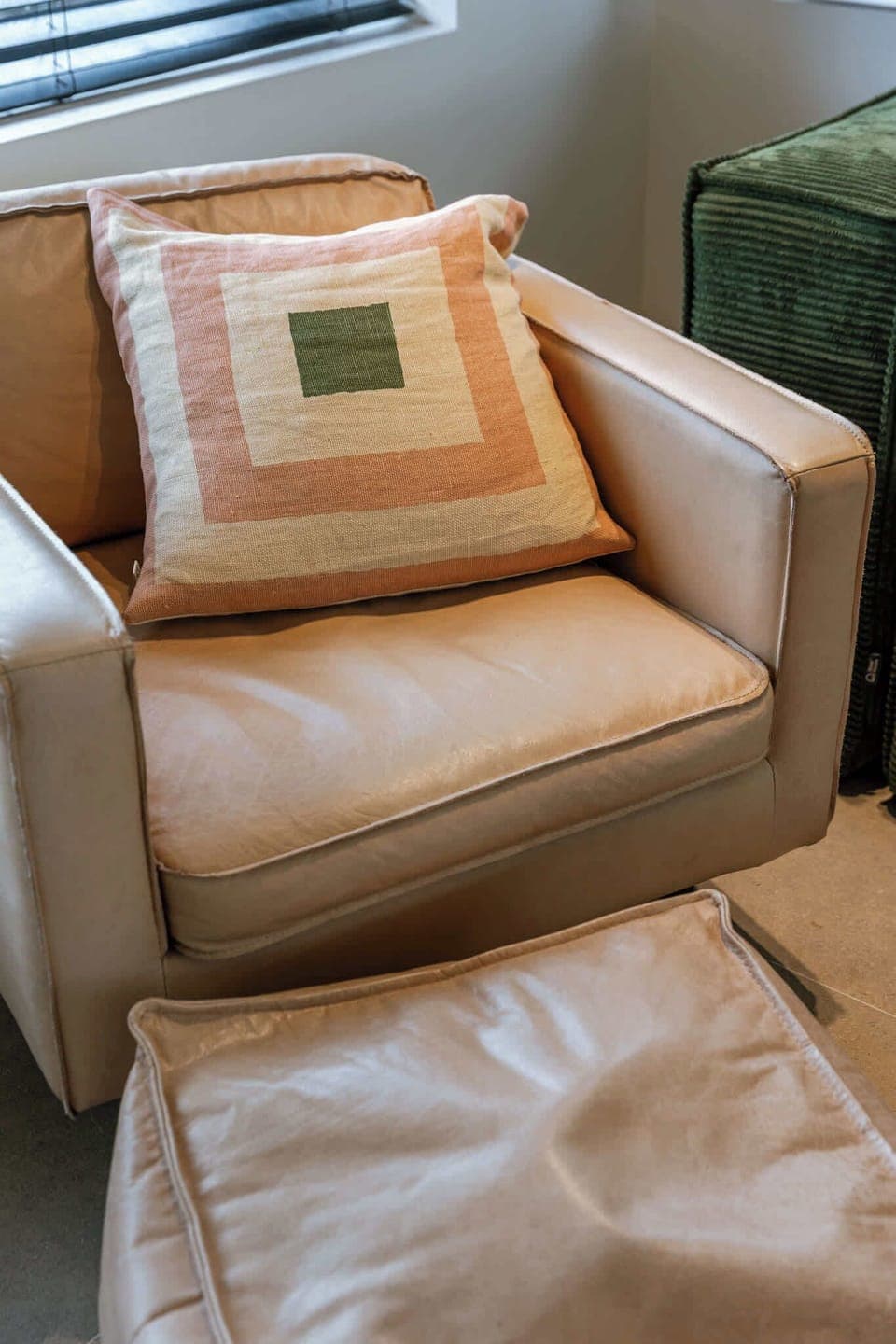 Soft armchair with pillows for an inviting reading spot.