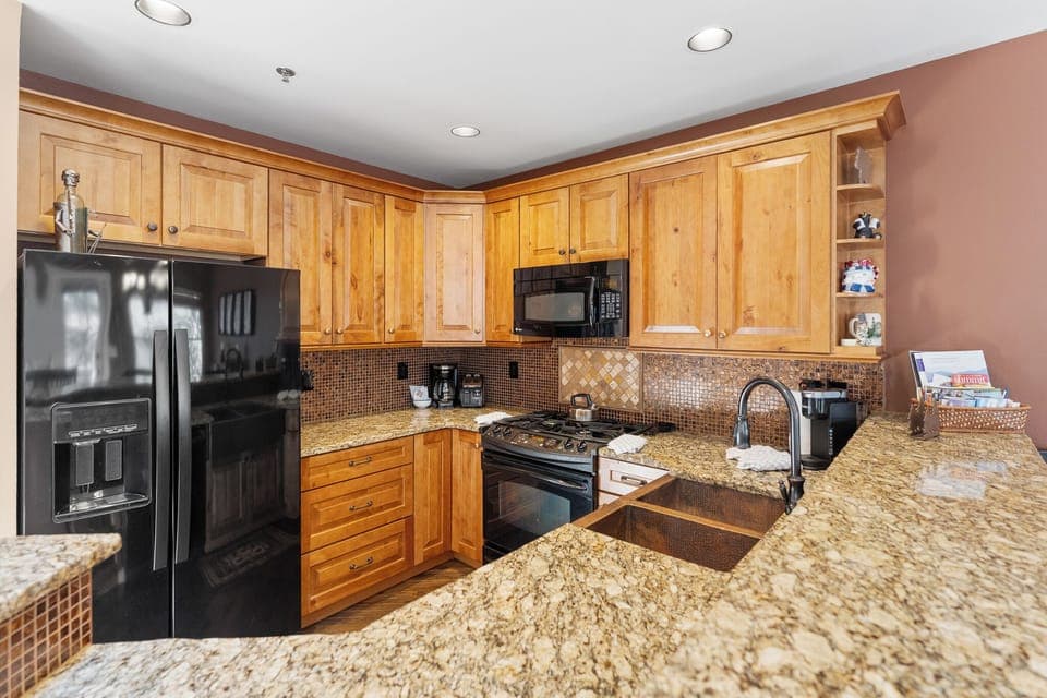 The full kitchen features granite countertops.