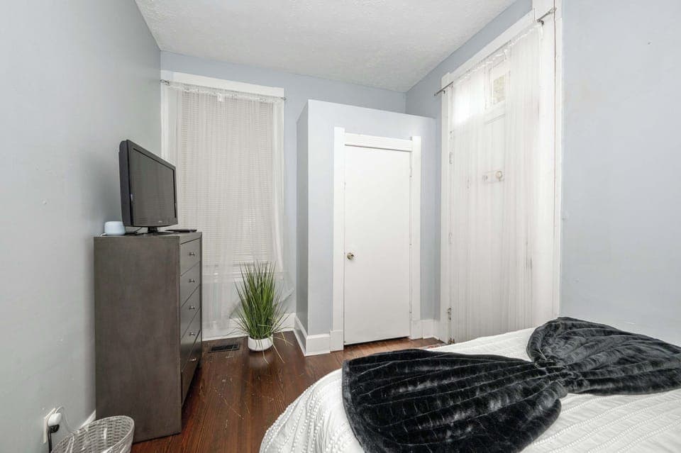 The serene bedroom retreat includes a queen-sized bed & smart TV​