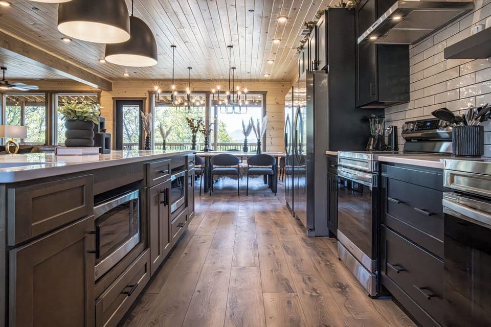 Sister Cabin Photo - Step into a chef’s paradise! This fully equipped modern kitchen features high-end appliances, ample counter space, and stunning views—perfect for cooking and gathering with loved ones.