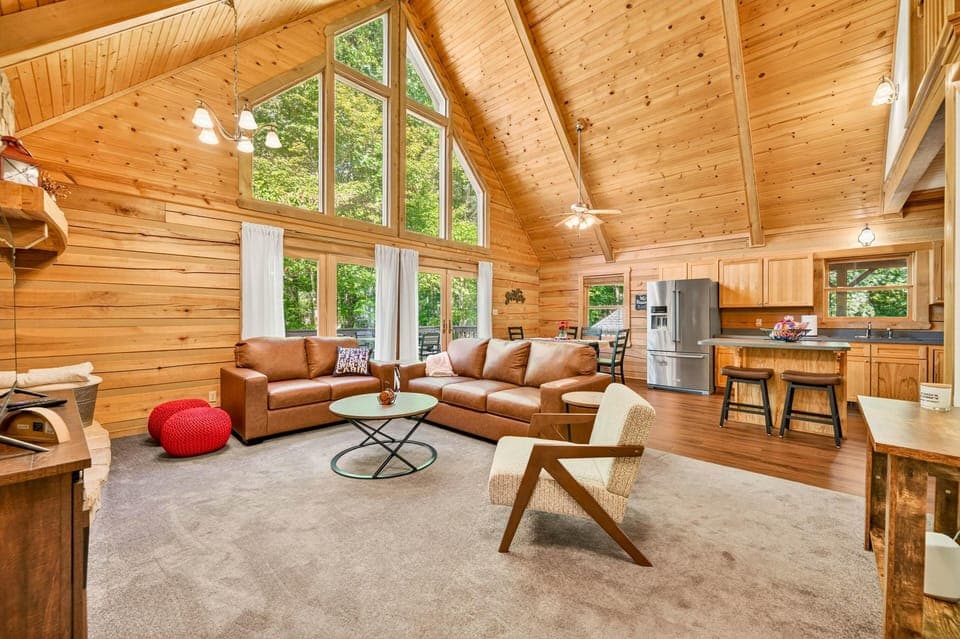 Spacious log cabin living room with vaulted ceilings and cozy seating