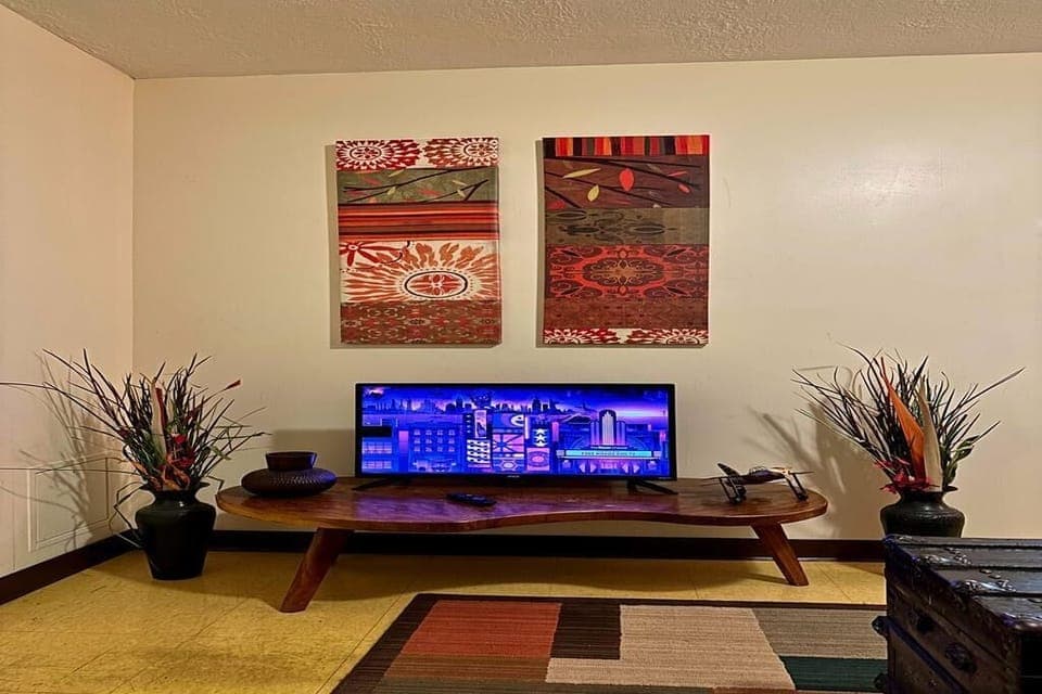 TV lounge with bold patterns, floor seating, and global-inspired wall art