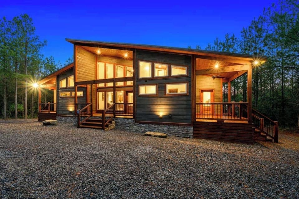 Welcome to Redfern Retreat, a picture-perfect luxury cabin tucked beneath towering pines—complete with covered decks, forest views, and rustic-modern charm from every angle.