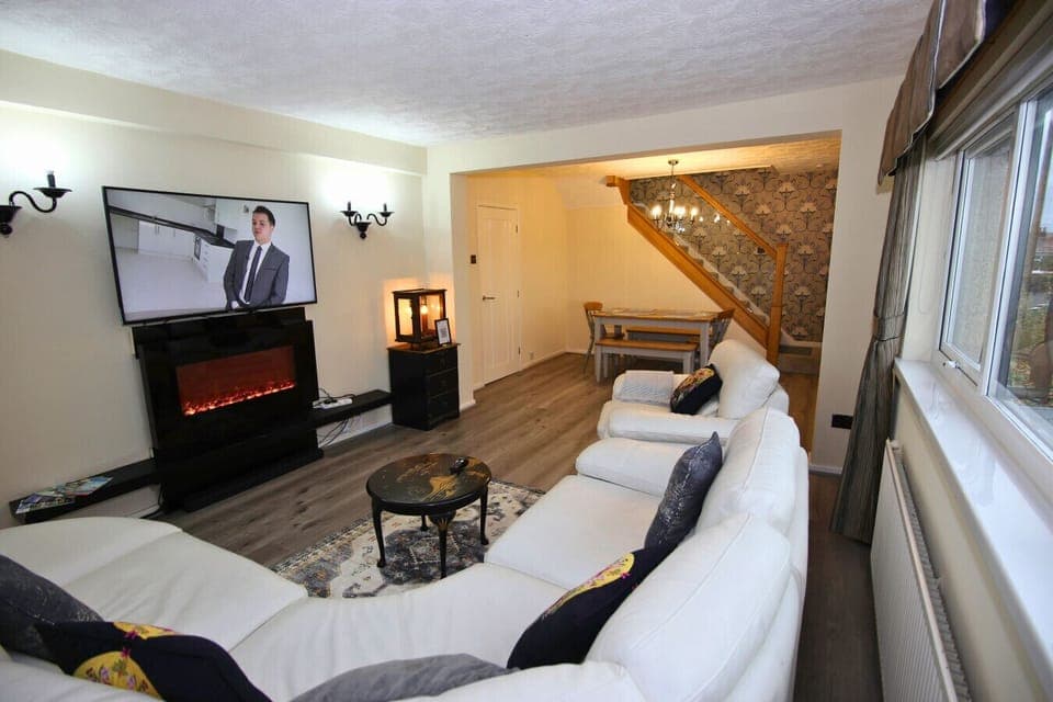 Relax in the spacious living area with modern fireplace and TV