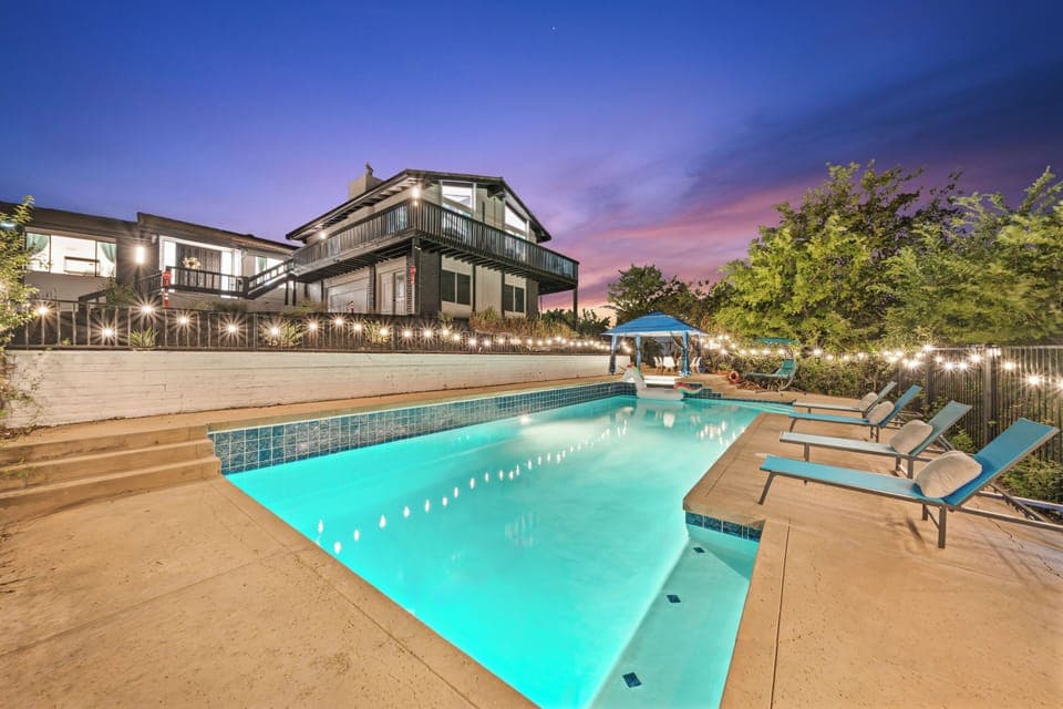 Relax by the illuminated pool and enjoy the peaceful night breeze.