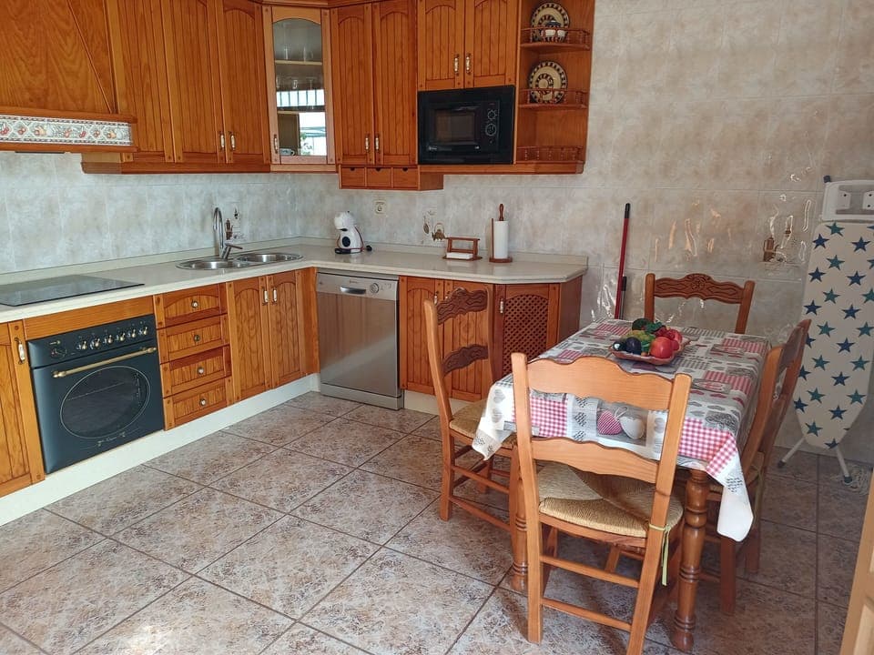 the kitchen: table & chairs, kitchen units and cupboards, cooker,& dishwasher.