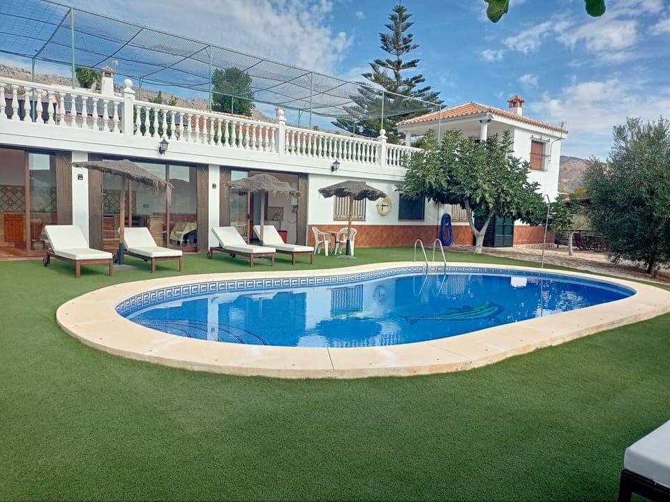 the pool area of Finca la Casilla, with the downstairs kitchen in the background