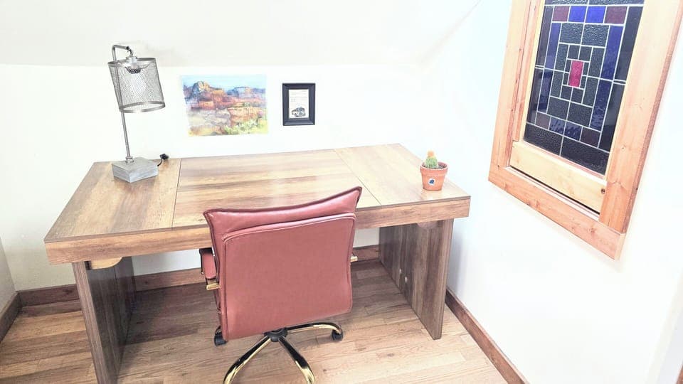 Work from home space with large desk and comfy leather rolling chair