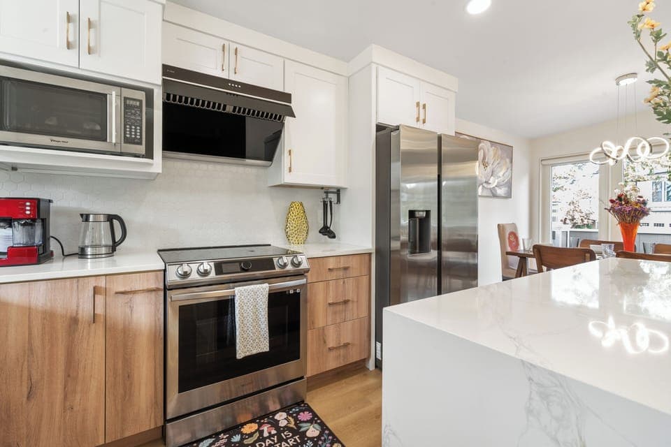 Modern kitchen with high-end appliances, espresso maker, and cooking essentials