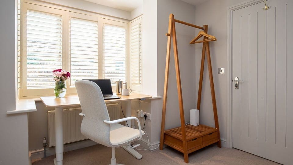 A quiet corner, the office has a desk which can be used as a standing desk and a chair.