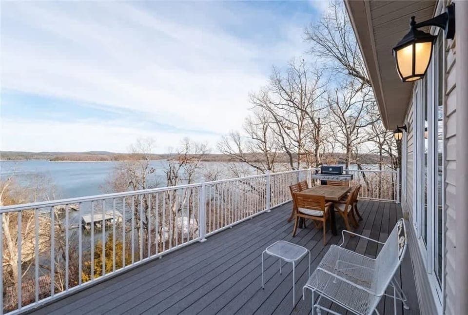 Deck with dining table and lounge chairs overlooking the lake—ideal for morning coffee, evening cocktails, and sunsets.