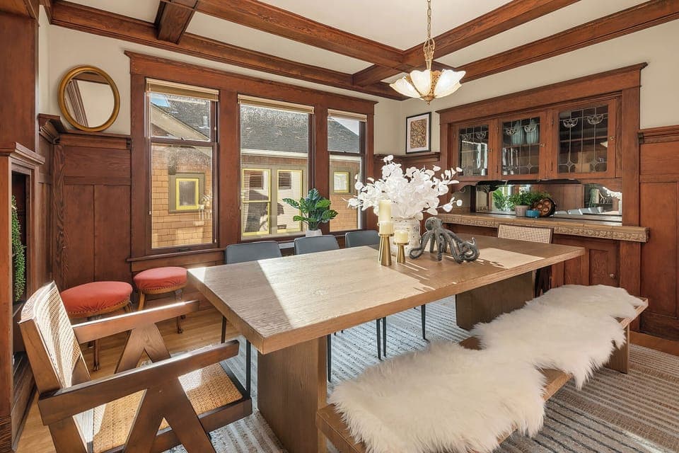 Sunlit dining area with classic woodwork and modern accents.
