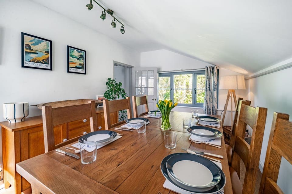 Ground floor: Dining room with a dining table set for six, but with ample seating for eight