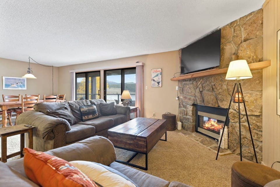 Living room with smart TV and gas fireplace.