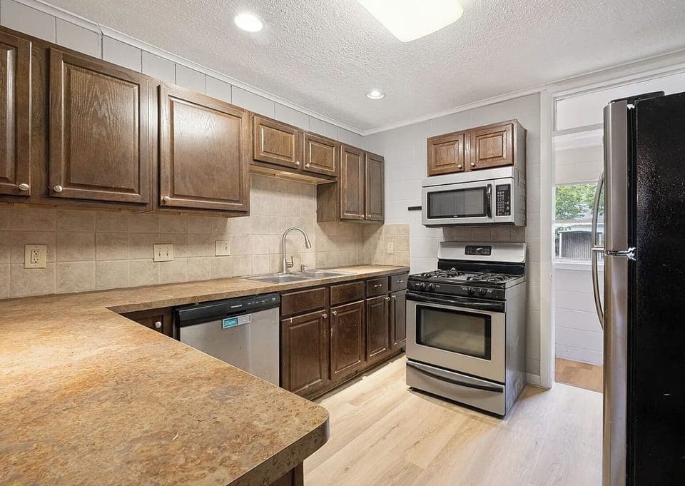 Kitchen, gas stove, microwave, and fridge