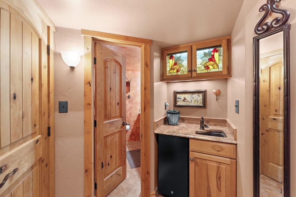 Wet bar and entry to the guest bathroom.