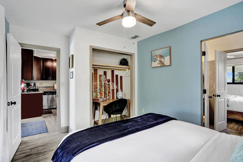 Cozy bedroom with queen bed and workspace—comfortable and convenient.
