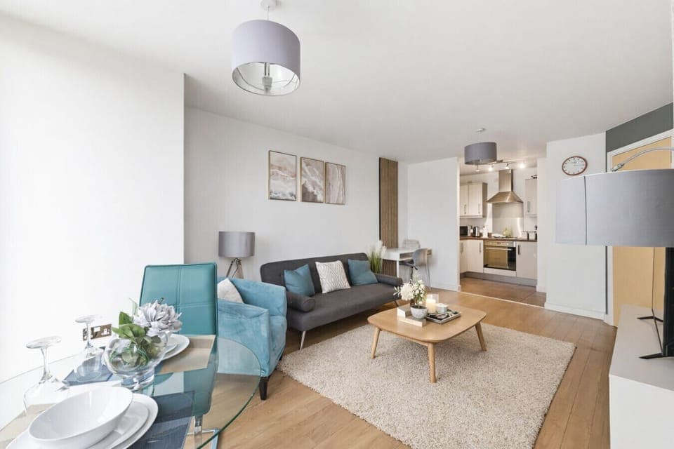 A bright and spacious living room featuring comfortable seating and a 50” TV, perfect for relaxing and unwinding during your stay