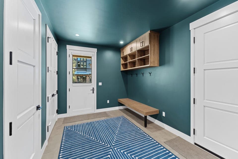 Entryway with a storage bench and hooks.