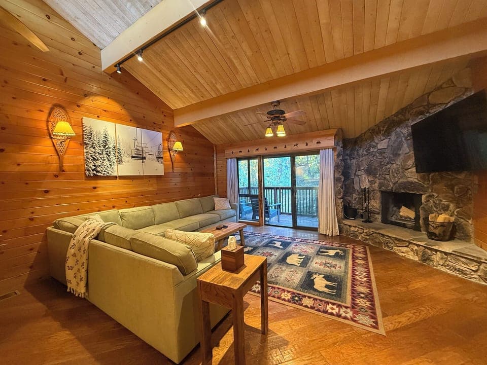 Gather, unwind and take in the view in this    open living room with fire place