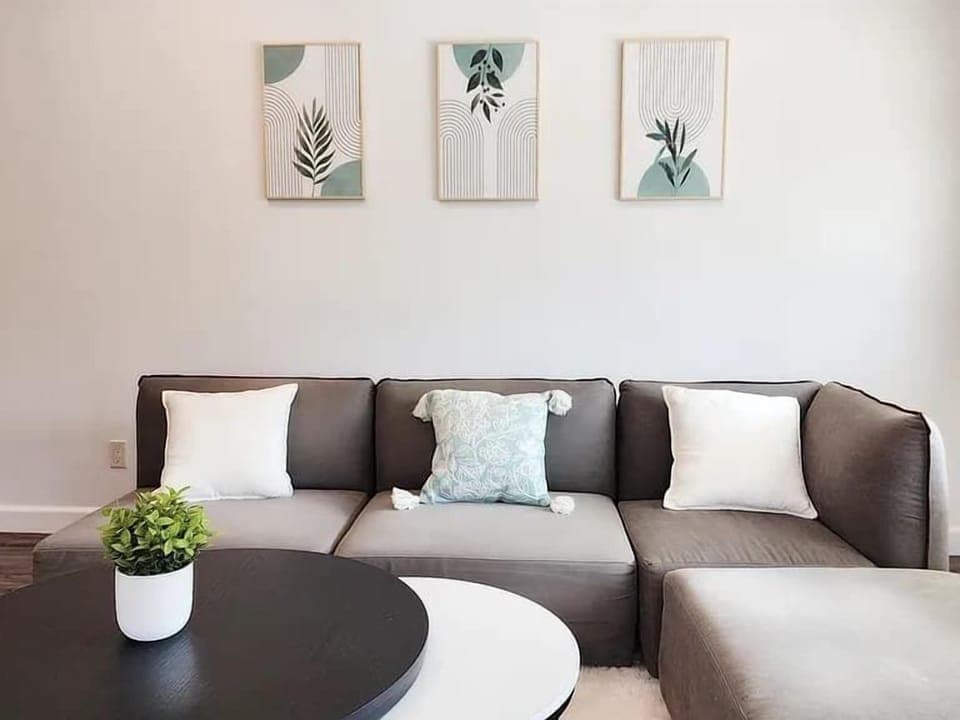 Relax in this sun-filled space with a comfy sectional and modern décor, perfect for movie nights or quiet mornings.