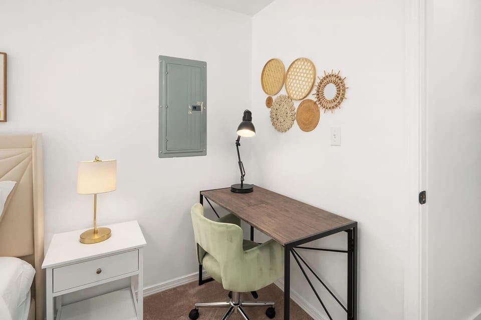 A perfect workspace for productivity, complemented by charming wall decor and a comfy chair.