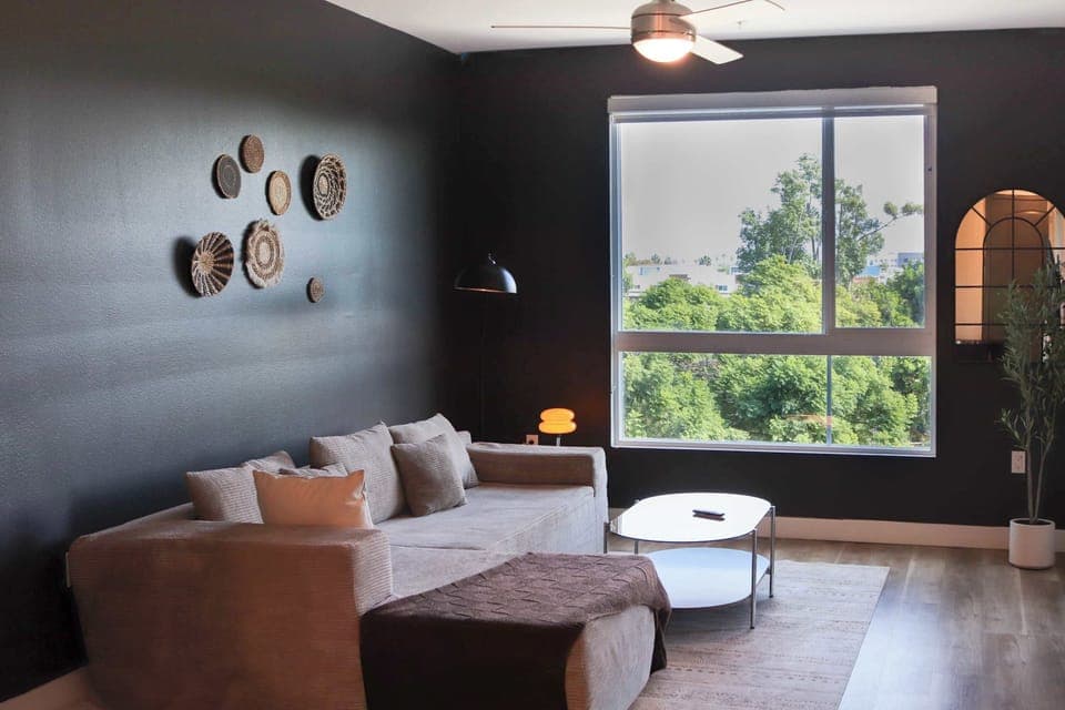 Spacious living room with a 65" Smart TV with preloaded access to Netflix, Hulu, and Disney+, all set up for your enjoyment.