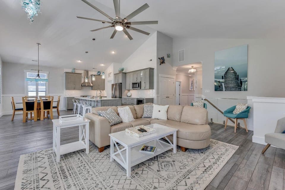 Unwind in your open-concept living space with soaring ceilings, stylish furnishings, and a fully equipped kitchen perfect for creating memorable meals.