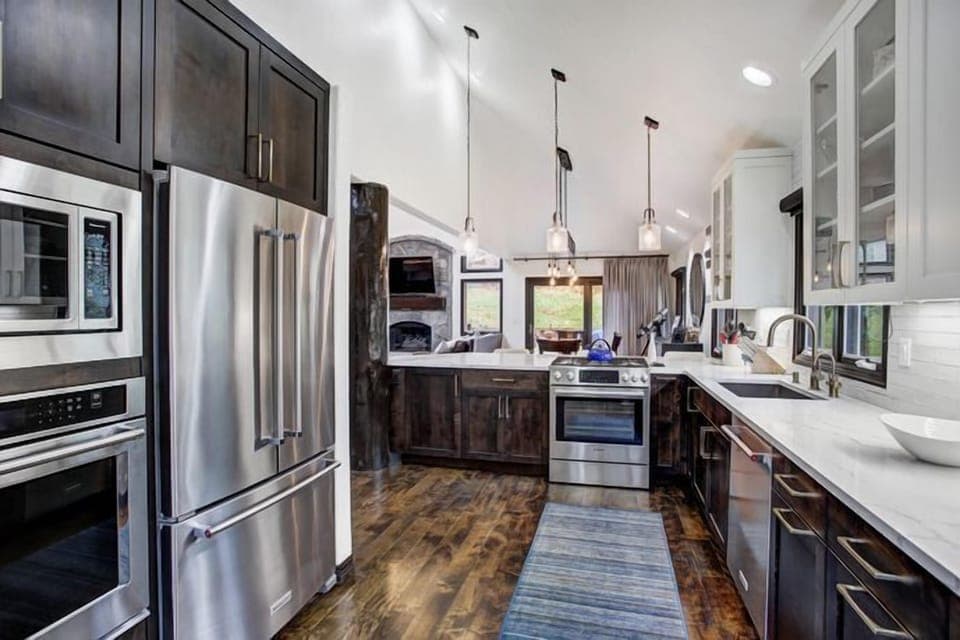The stylish kitchen features modern appliances and a spacious layout, perfect for family gatherings after a day on the slopes.