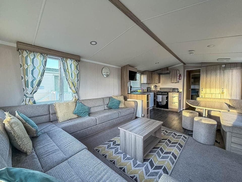 Cozy living room with plush seating and modern kitchen amenities