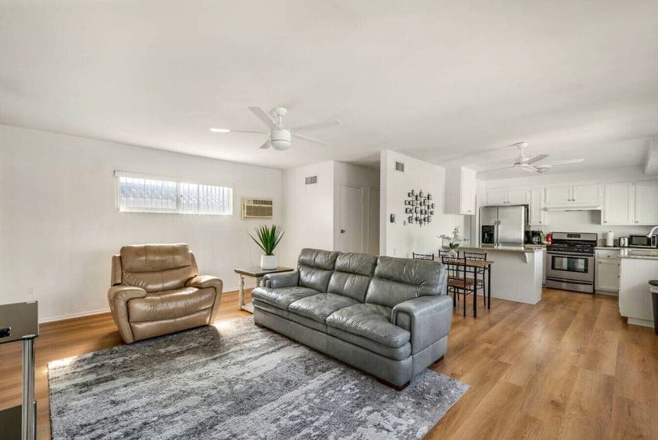 Bright open-concept living space with comfy seating and a fully equipped kitchen.