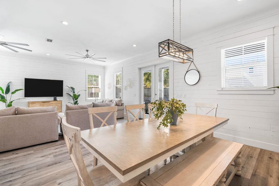 A sunlit dining table with effortless access to the patio and pool beyond.