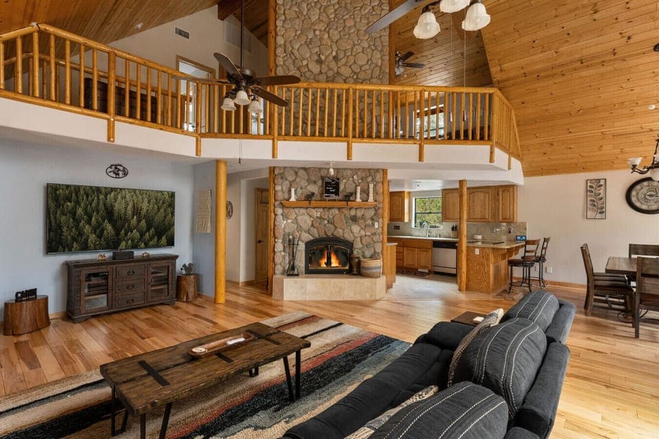 Cozy living space with a stone fireplace and smart TV.