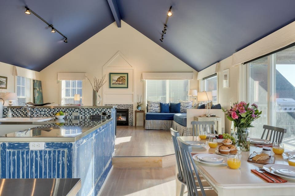 This open-concept living area offers seamless transitions from the living area to the dining area to the kitchen. 