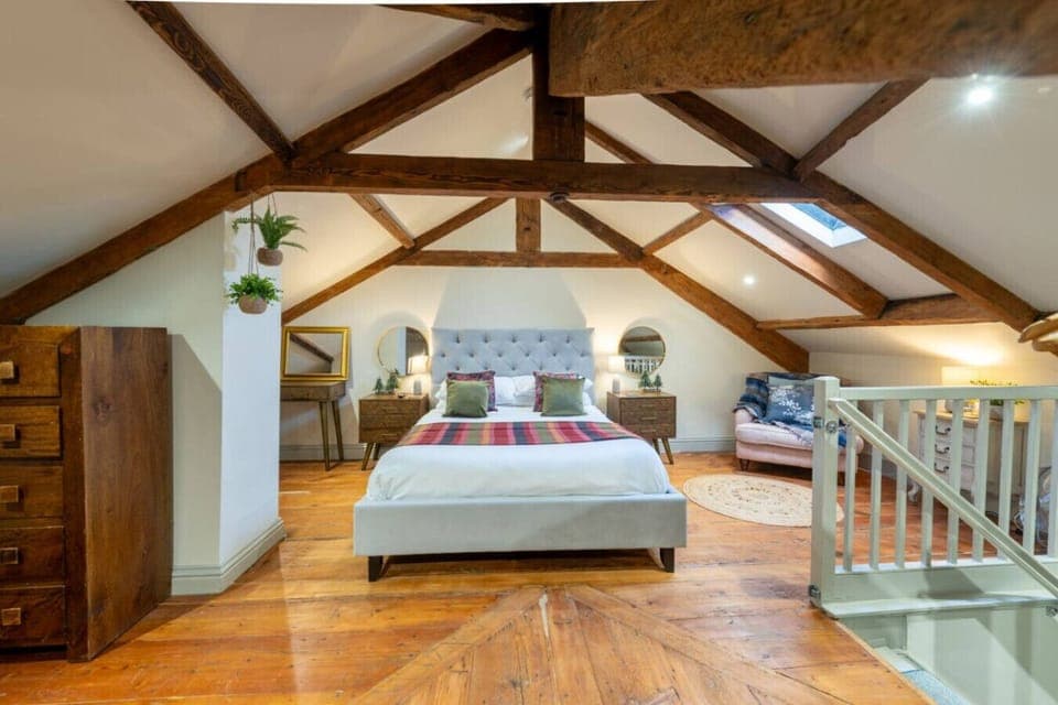 Relax in a serene bedroom with cosy, rustic décor and natural light.