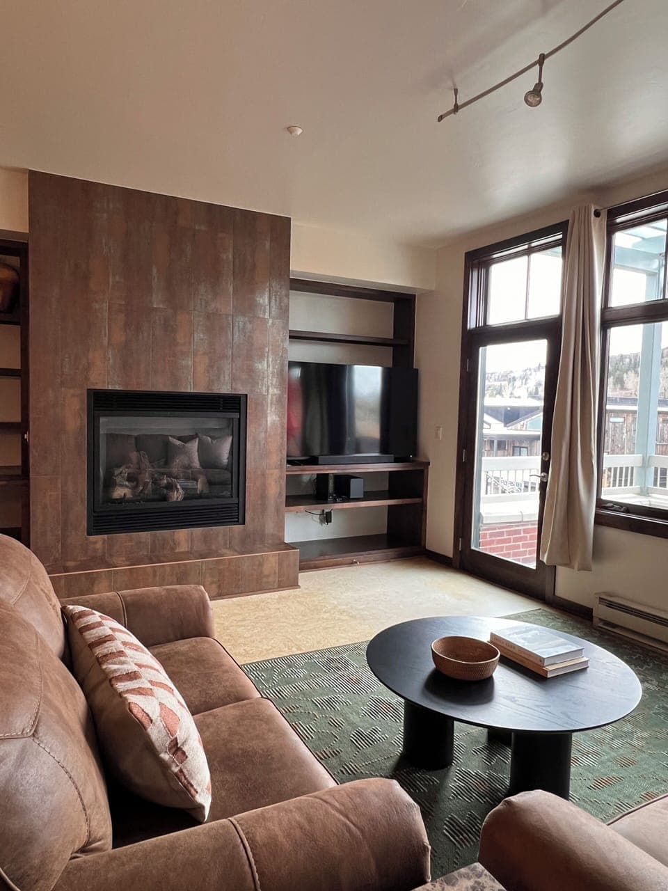 Living room with fireplace, sofa bed and Roku Smart TV with streaming