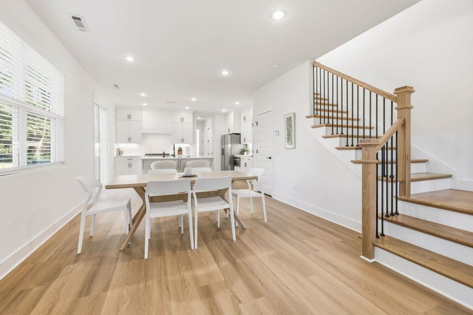 This space features plush seating, a large Smart TV, dining table for 6, and a large kitchen island with bar seating.