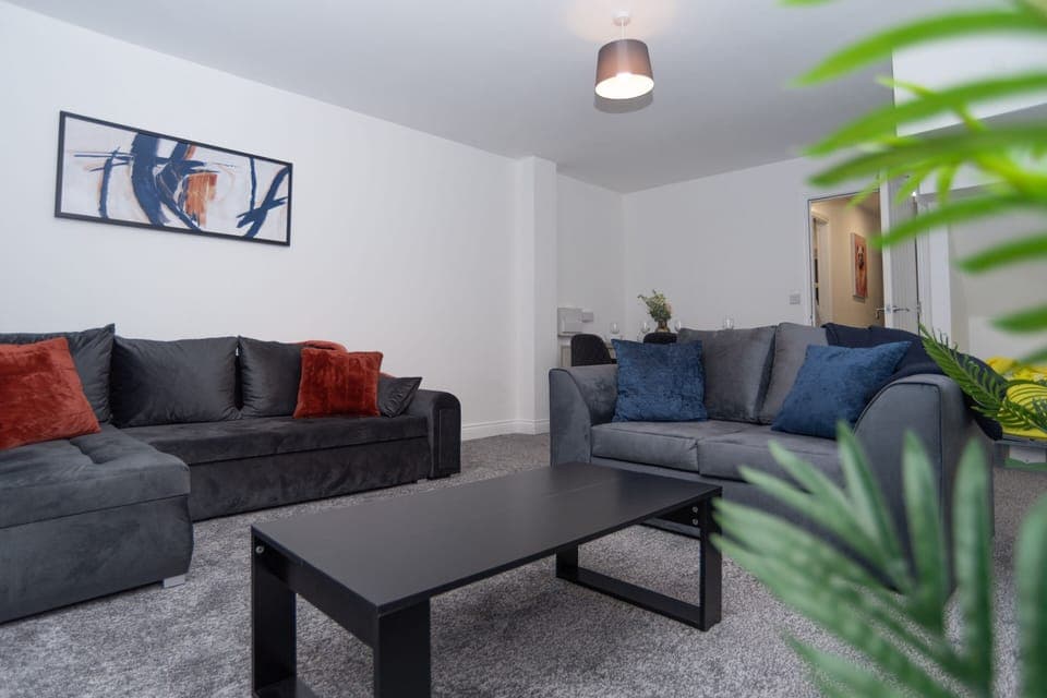 Spacious, comfortable living area with dual sofas and a versatile sofa bed.