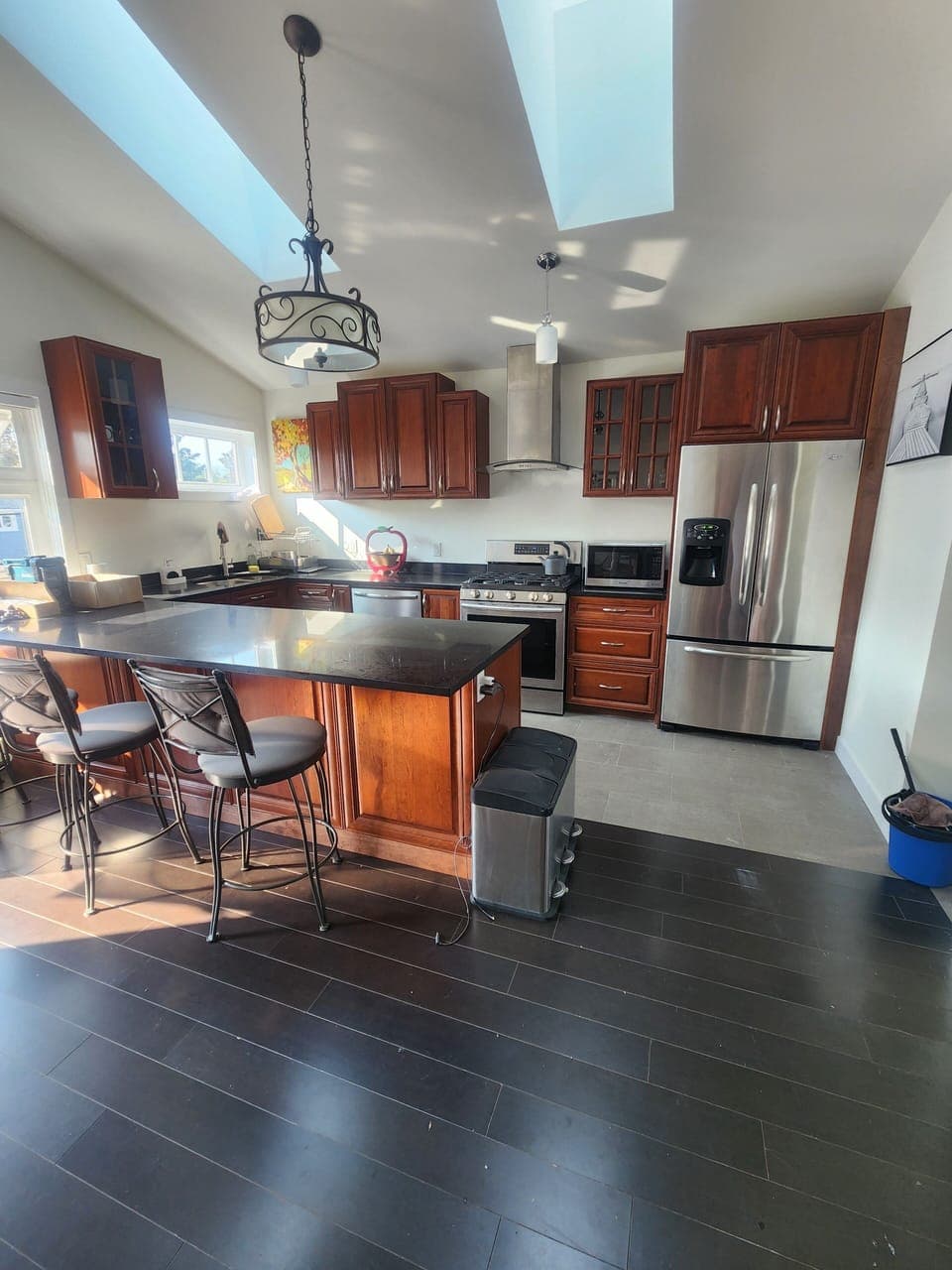 full open concept kitchen with 4 seater kitchen island and gas appliances
