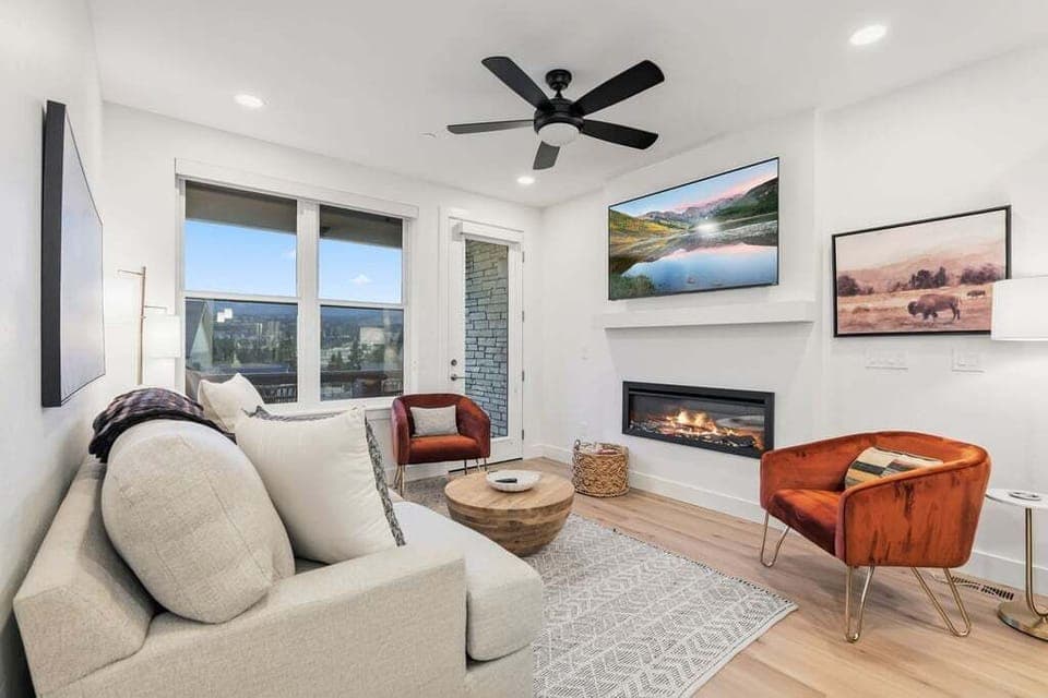 Relax in your modern living space with cozy fireplace, city views, and stylish furnishings for the perfect retreat.