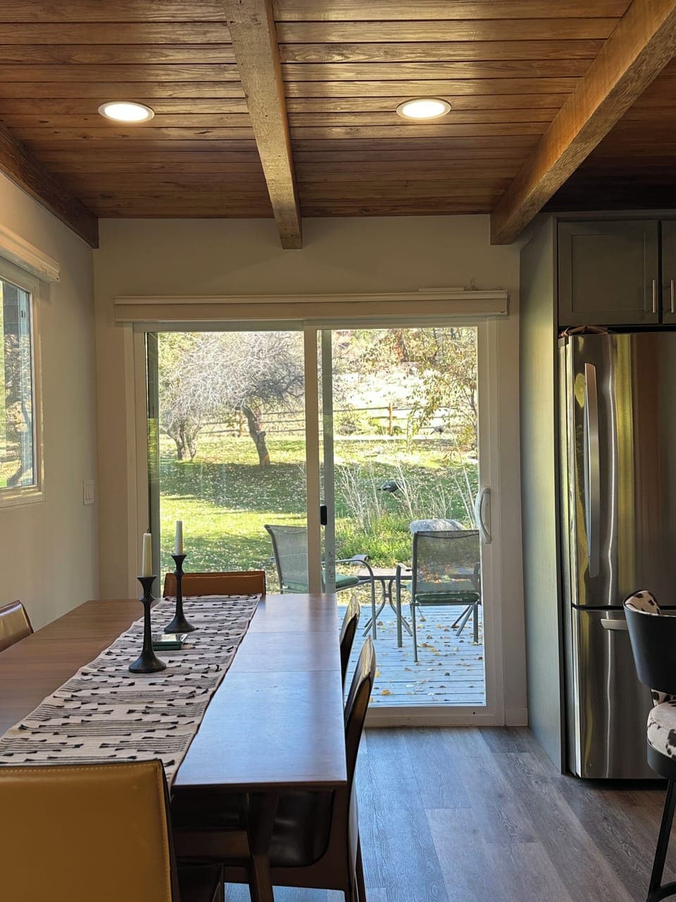 Sunlit dining area opens to the deck, perfect for indoor–outdoor meals and views
