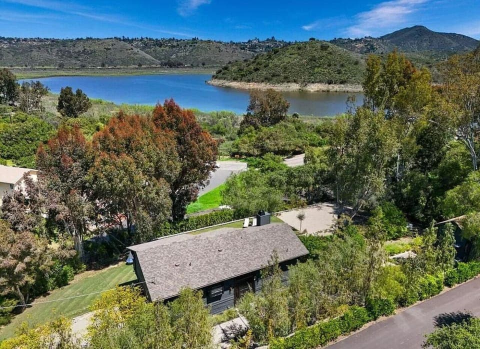 Aerial view showcasing the home`s prime location just steps from Lake Hodges, offering breathtaking lake views and easy access to outdoor activities.