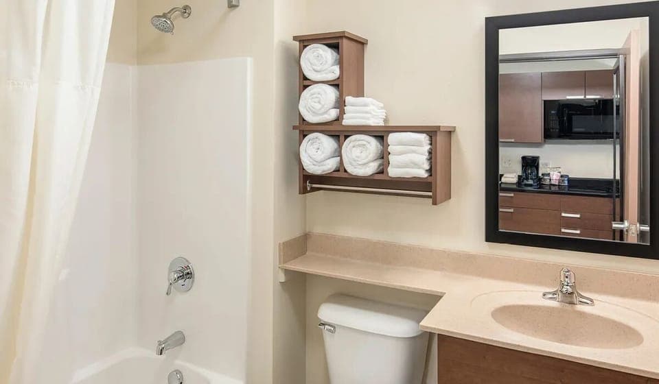Refresh with a spotless vanity and plush towels within reach.