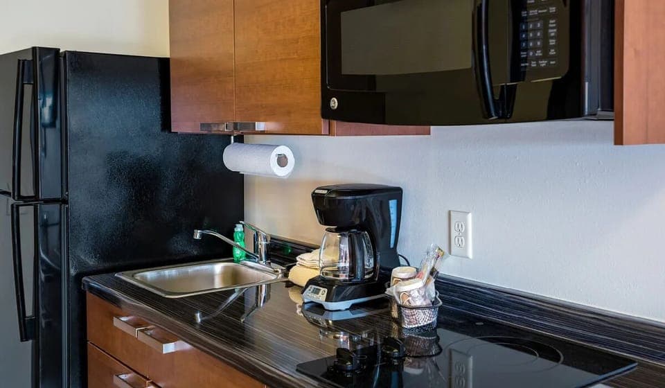 Start mornings smoothly with coffee, fridge, and microwave close by.