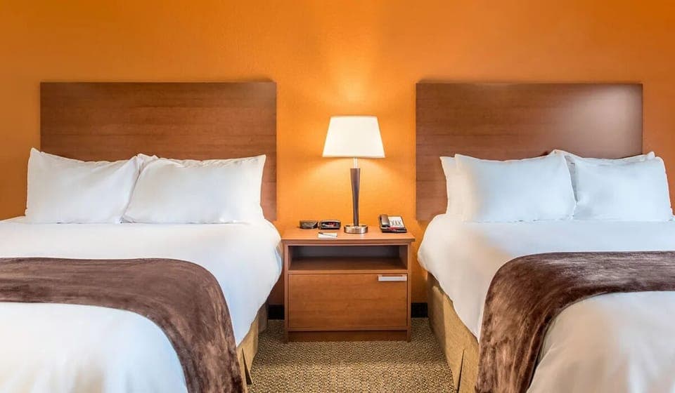 Relax between two plush queen beds and warm lighting.