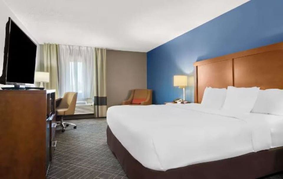 Unwind in a bright room with plush linens and workspace.