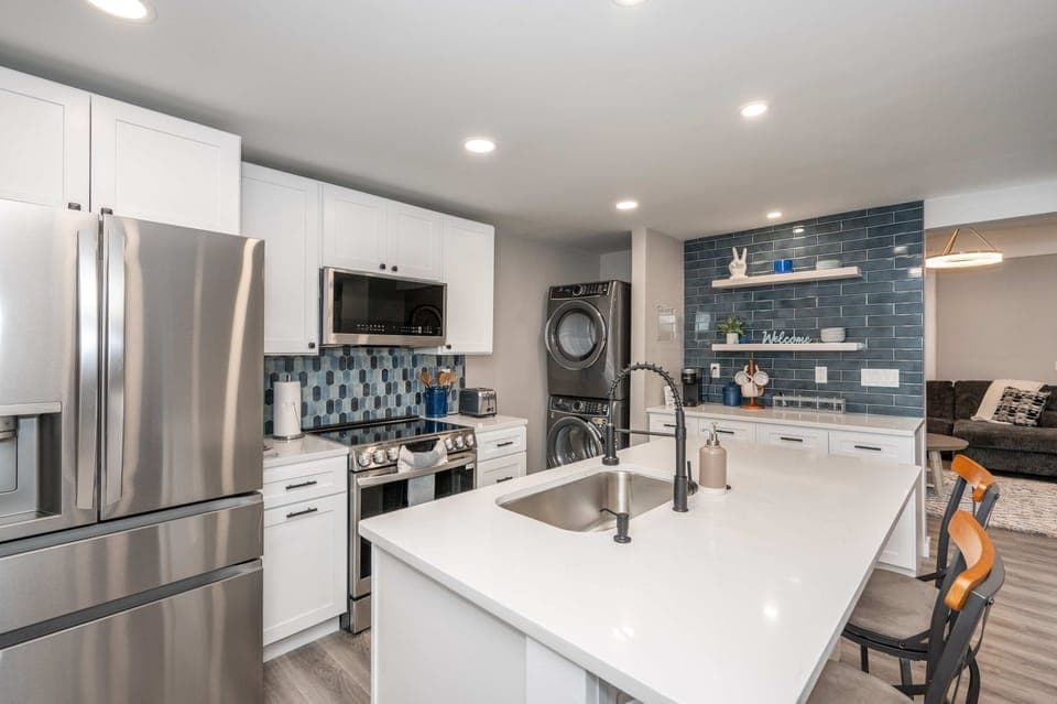 The chic, open kitchen offers ample space & all the comforts of home​